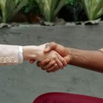 Close-up of diverse hands shaking indoors, symbolizing partnership and agreement.